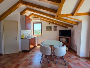 a kitchen and dining room with a table and chairs at Apartments AstaLaVIsta in Okrug Donji