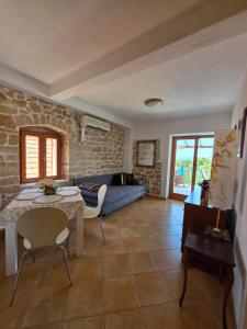 a living room with a couch and a table at Apartments AstaLaVIsta in Okrug Donji