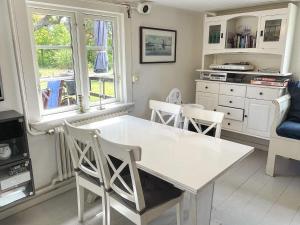 a kitchen with a white dining table and chairs at 4 star holiday home in TORHAMN-By Traum in Torhamn