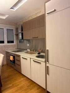 a kitchen with a white refrigerator and a sink at Swimming pool apartment in Budva