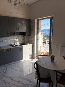 a kitchen with a table and a dining room at stavros house byzarkco in Porto Rafti