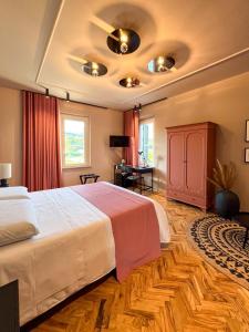 a bedroom with a large bed and a desk at Villa Scarpino in Massignano