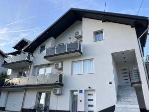 a white building with balconies on it at Apartman Rawda in Jajce