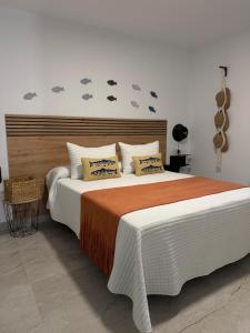 a bedroom with a large bed with clouds on the wall at Alojamientos LUMARA in Peal de Becerro