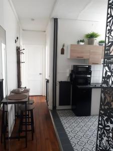 a small kitchen with a table and a stove at Vincennes - Parisian appartment in Vincennes