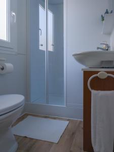 a bathroom with a white toilet and a sink at Lavender Mobile Houses in Pakoštane