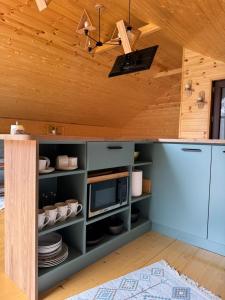 a kitchen with blue cabinets and a ceiling at Cabin AISI in (( Gergeti ))