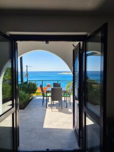 a view of the ocean from the balcony of a house at Sunset Zaglav Apartment in Martinšćica