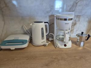 a coffee maker and a blender sitting on a counter at Sunset Zaglav Apartment in Martinšćica