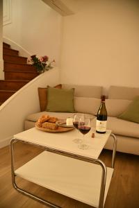 a living room with a table with a glass of wine at Le Cocon de Pommard in Pommard