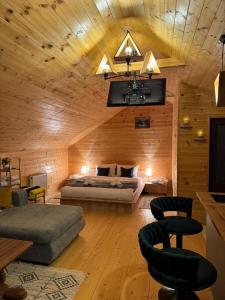 a bedroom with a bed in a wooden cabin at Cabin AISI in (( Gergeti ))