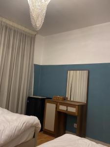 a bedroom with a mirror on a table and a bed at Sky bed in Madinaty