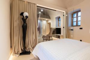 a bedroom with a black floor lamp in a room at Ali Baba Apartment in Mostar