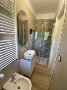 a bathroom with a sink and a shower at La casina di Viola in Posticciola