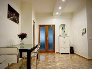 a dining room with a table and a refrigerator at Ca dei Cappuccina in Mestre
