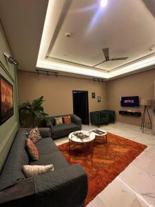 a living room with a couch and a tv at River Hill in Rawalpindi