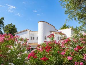 a white house with pink flowers in front of it at Villa Daurus in Vallauris