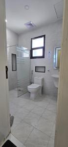 a bathroom with a toilet and a shower and a sink at دان إقامة هادئة in Medina