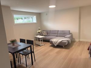 a living room with a couch and a table at Cozy home in Burnaby +11 photos