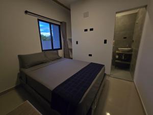 a bedroom with a bed and a window and a bathroom at Villa Yasmin in Prado +5 photos