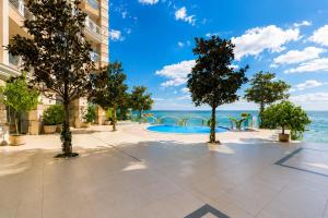 a resort with a pool and trees and the ocean at Luxurious and panoramic apartments at the beach in La Mer complex in Golden Sands