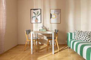 a dining room with a table and chairs and a bed at PINE&SHINE Waterfront in Podgora