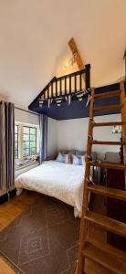 a bedroom with a bunk bed and a ladder at The little Hotel-luxury home in Motcombe