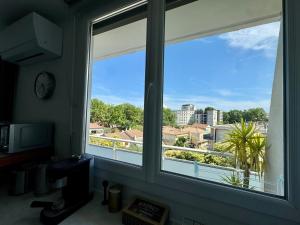 a window in a room with a view of a city at Appartement Port Marianne Montpellier in Montpellier
