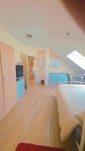 a room with a bed and a room with a kitchen at studio with ensuite in New Bedfont