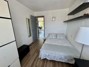 a small bedroom with a bed and a mirror at Appartement Port Marianne Montpellier in Montpellier +65 photos