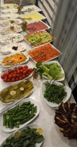 a long table with plates of food on it at Pera City Otel in Samsun