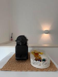 a black toaster sitting on top of a kitchen counter at Al58 Casa Vacanze in Villasmundo +6 photos