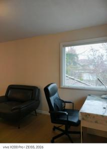 a room with a desk and a chair and a window at Cozy Room With King-sized Bed in Richmond