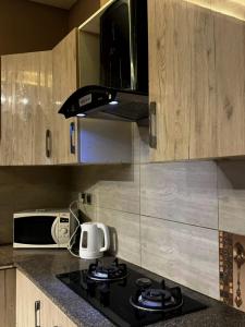 a kitchen with a stove with a toaster and a microwave at River Hill in Rawalpindi