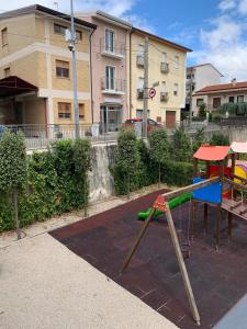 a playground in front of a building at Da Mina Rooms & Apartament in Flumeri