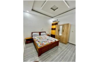 a bedroom with a bed in a room at Résidence ADJOBIA - Grâce divine YAMOUSSOUKRO in Yamoussoukro