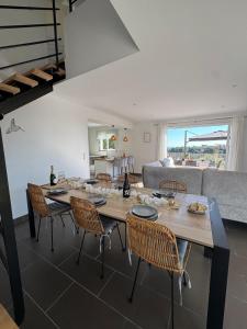 a dining room with a large wooden table and chairs at Villa Mathilde - 3 Chambres - Jacuzzi in Béziers