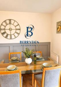 a dining room with a table and a clock at Restmore House in Inverugie Mill