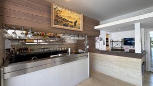 a bar in a restaurant with a counter at Rovotel - Le Rove in Le Rove