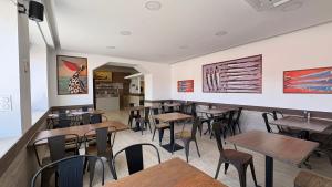 a dining room with tables and chairs in a restaurant at Rovotel - Le Rove in Le Rove +23 photos