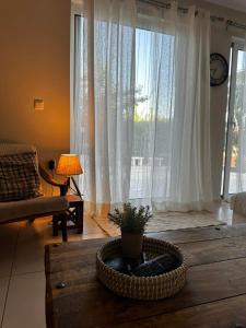 a living room with a table and a large window at Lithos in Khalkoútsion
