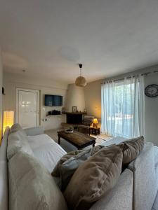 a living room with a couch and a table at Lithos in Khalkoútsion