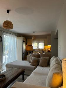 a living room with a couch and a table at Lithos in Khalkoútsion +41 photos