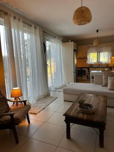 a living room with a bed and a coffee table at Lithos in Khalkoútsion