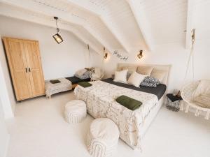 a bedroom with a bed and two chairs in it at CHARZYKOWSKIE TARASY in Charzykowy