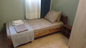 a small bed with a table in a room at House with garden in Agria