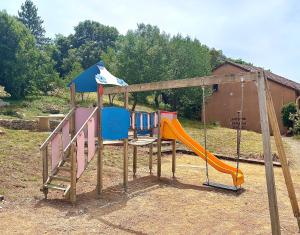 a playground with a slide and a swing at Maison proche vallon pont d arc in Salavas