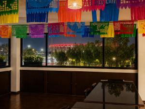 a room with a window with colorful flags at Mariachi House in Mexico City