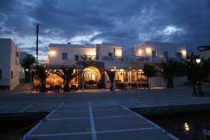 a building with a parking lot at night at Hotel Mantalena in Antiparos Town