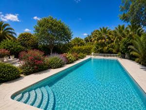 a swimming pool in a garden with plants at Villa Daurus in Vallauris